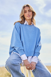 Model Tegan wearing size S of the Have You Seam Me Cotton Cashmere Jumper in colour Bluebird (Blue), from the front, showing the whole outfit