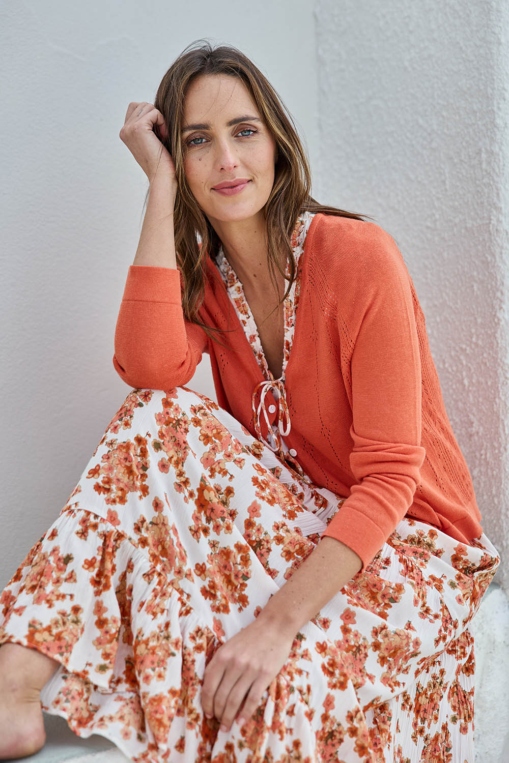 Model Tegand wearing size 10 of the Pretty In Pointelle Linen Blend Cardi – Sunset in colour Sunset, in a cropped view