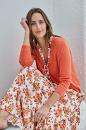 Model Tegand wearing size 10 of the Pretty In Pointelle Linen Blend Cardi – Sunset in colour Sunset, in a cropped view