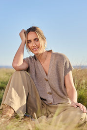 Model Tegan wearing size S of the Found My Friend Recycled Knit Sleeveless Cardi in colour Wood, from the front, showing the whole outfit