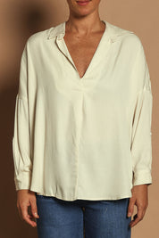 Model Katie wearing size 10 of the Easy Does It Popover Shirt in colour Latte, from the front, cropped image
