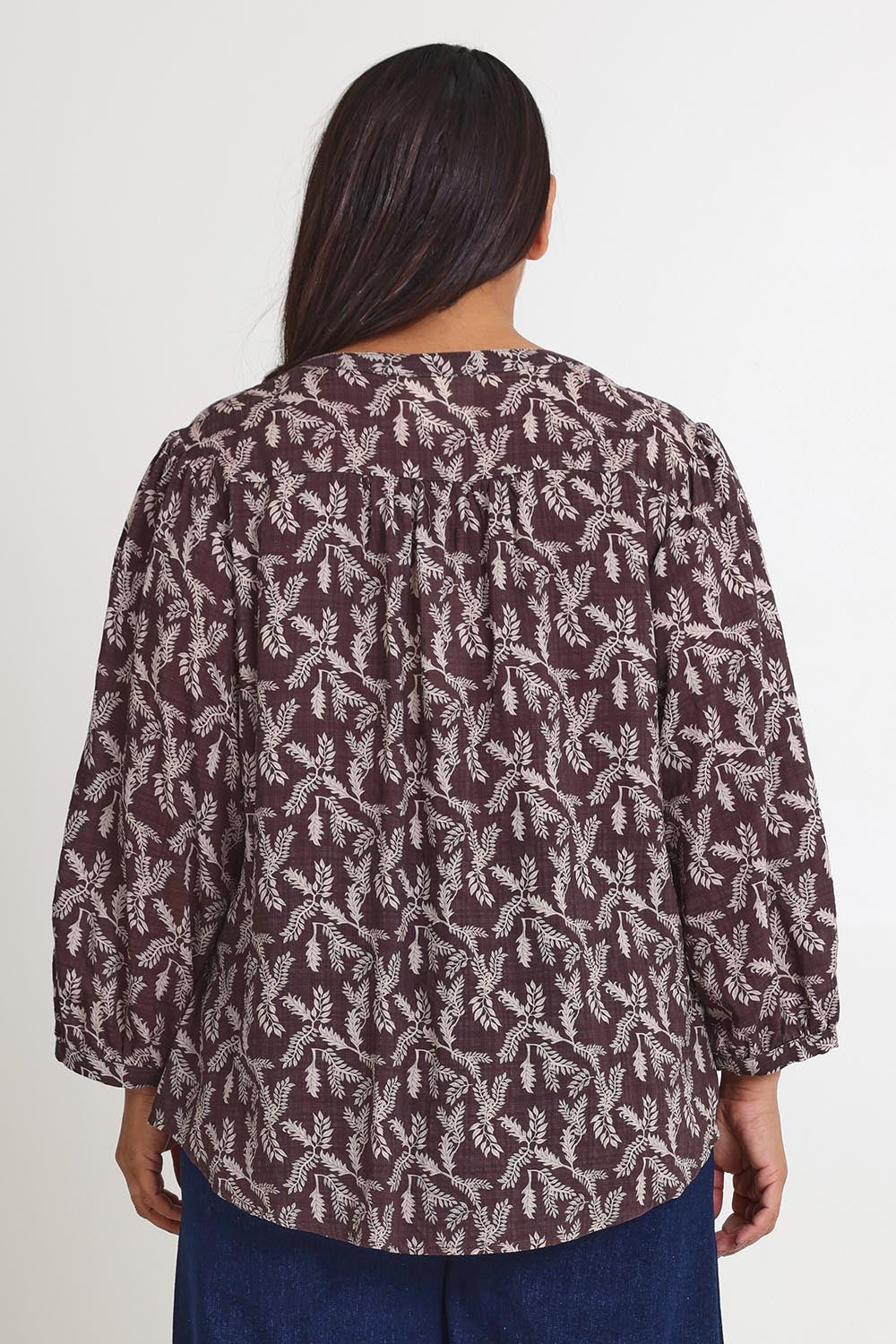 Model Ashleigh wearing size 16 of the Easy On Me Blouse in colour Charcoal (Grey), from the back
