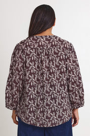 Model Ashleigh wearing size 16 of the Easy On Me Blouse in colour Charcoal (Grey), from the back