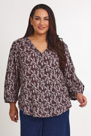 Model Ashleigh wearing size 16 of the Easy On Me Blouse in colour Charcoal (Grey), from the front, cropped image
