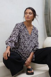 Model Tahnee wearing size 10 of the Easy On Me Blouse in colour Charcoal (Grey), from the front, showing the whole outfit