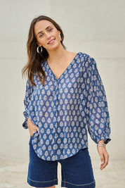 Model Tegand wearing size 10 of the Easy On Me Blouse - Denimfleur in colour Denimfleur, in a cropped view