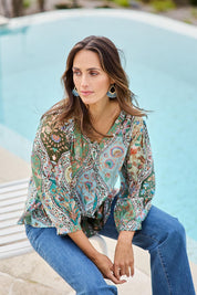 Model Tegand wearing size 10 of the Easy On Me Blouse – Greenfolk in colour Greenfolk, in a cropped view