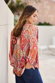 Model Tegand wearing size 10 of the Easy On Me Blouse – Rustfolk in colour Rustfolk, from an angle