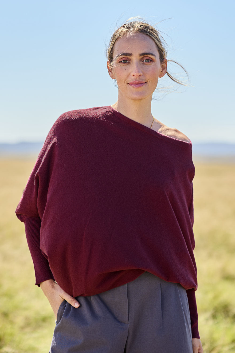 Model Tegan wearing size S of the Snuggle Up True Knit Jumper in colour Plum (Purple), from the front, cropped image