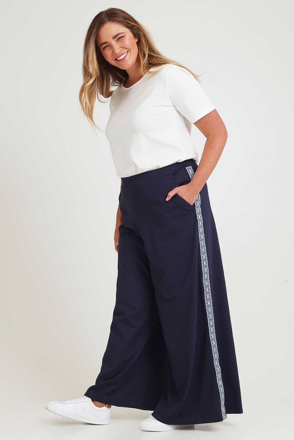 Model Chanel wearing size 16 of the Follow My Lead Side Stripe Pants in colour Navy (Blue), from the front, showing the whole outfit