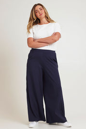 Model Chanel wearing size 16 of the Follow My Lead Side Stripe Pants in colour Navy (Blue), from the front, showing the whole outfit