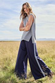 Model Tegan wearing size 10 of the Follow My Lead Side Stripe Pants in colour Navy (Blue), from the front, showing the whole outfit
