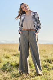 Model Tegan wearing size 10 of the Walk This Way Wide Leg Pants in colour Chocstripe, from the front, showing the whole outfit