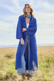 Model Tegan wearing size S of the Delight Me Long Cotton Cardi in colour Electric (Blue), from the front, showing the whole outfit