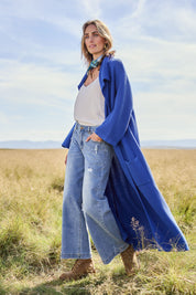 Model Tegan wearing size S of the Delight Me Long Cotton Cardi in colour Electric (Blue), from the front, showing the whole outfit