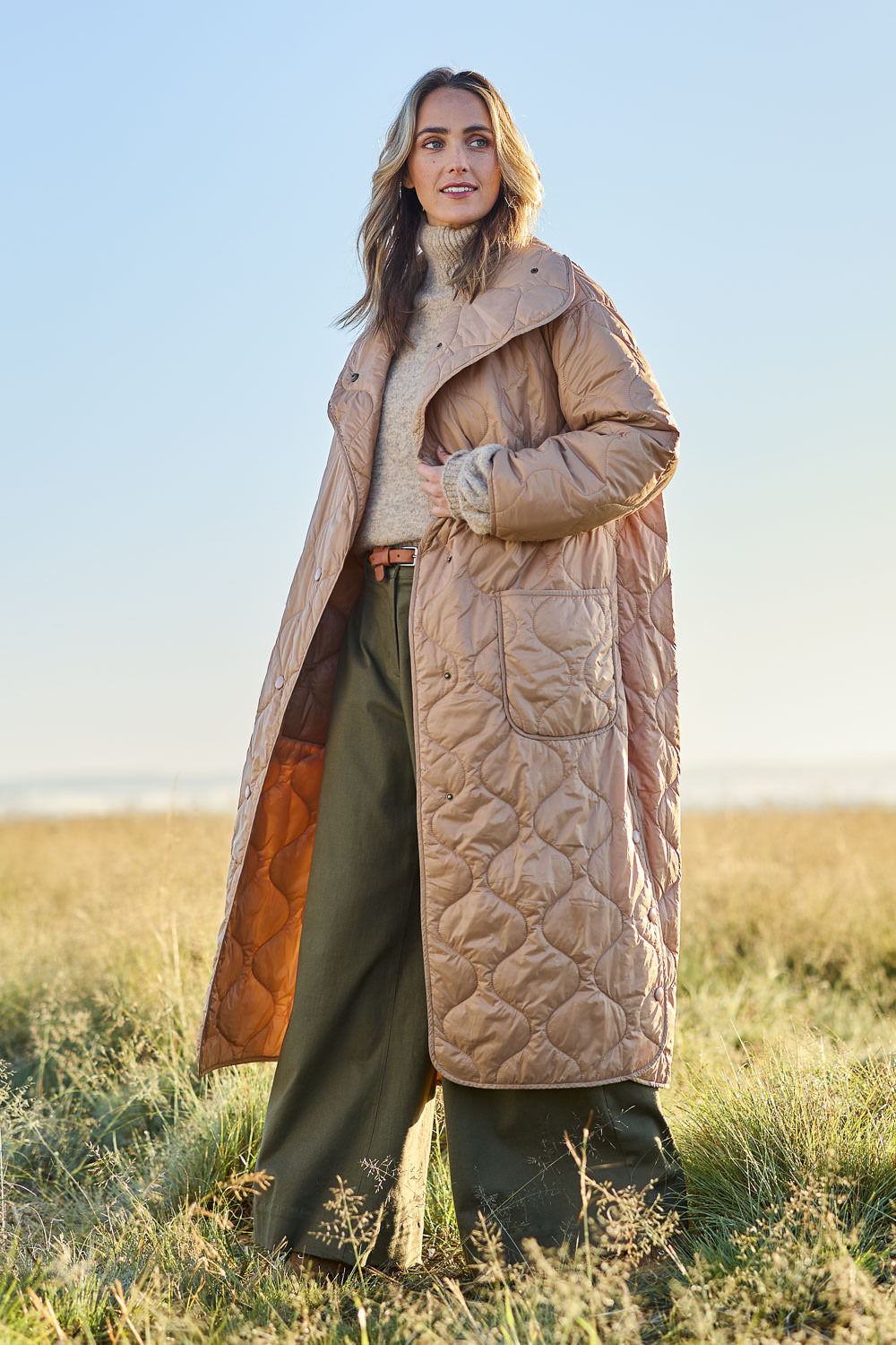 Model Tegan wearing size 10 of the Heart Warming Oversized Quilted Jacket in colour Earth, from the front, showing the whole outfit