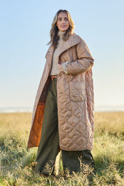 Model Tegan wearing size 10 of the Heart Warming Oversized Quilted Jacket in colour Earth, from the front, showing the whole outfit