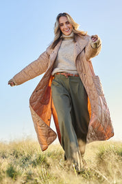 Model Tegan wearing size 10 of the Heart Warming Oversized Quilted Jacket in colour Earth, from the front, showing the whole outfit