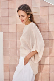 Model Tegand wearing size 10 of the Summer Ready Cotton Throw Sweater – Natural in colour Natural, from an angle