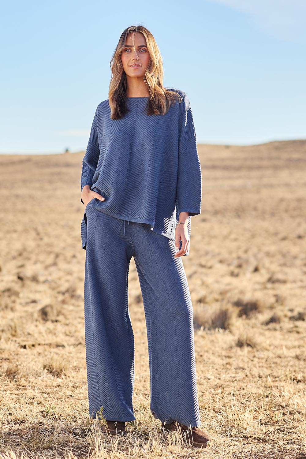 Model Tegan wearing size S of the Easy Does It Knit Top in colour Denim (Blue), from the front, showing the whole outfit