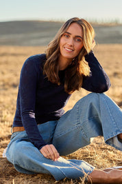 Model Tegan wearing size S of the Love Layer Long Sleeve Knit Top in colour Navy (Blue), from the front, showing the whole outfit