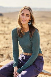 Model Tegan wearing size S of the Love Layer Long Sleeve Knit Top in colour Sage (Green), from the front, showing the whole outfit