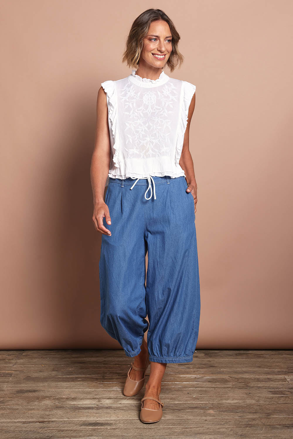 Model Riina wearing size 10 of the Summer Daze Denim Pull On 3/4 Pant in colour Denim (Blue), from the front, showing the whole outfit