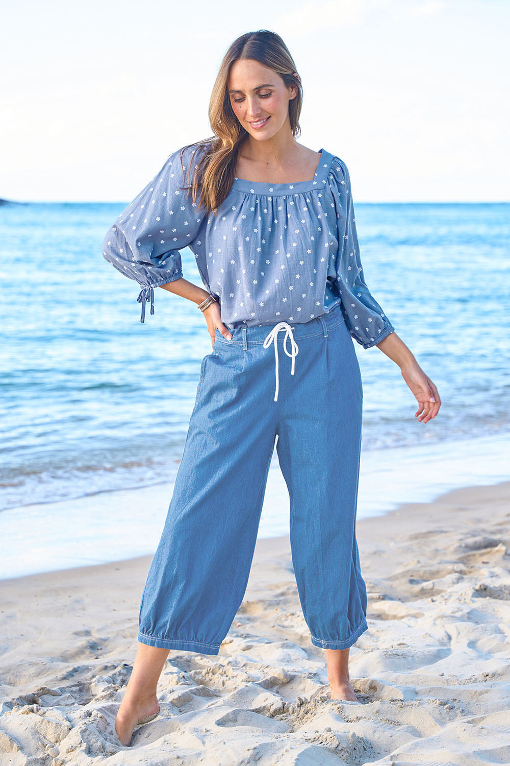 Model Tegan wearing size 10 of the Summer Daze Denim Pull On 3/4 Pant in colour Denim (Blue), from the front, showing the whole outfit