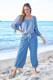 Model Tegan wearing size 10 of the Summer Daze Denim Pull On 3/4 Pant in colour Denim (Blue), from the front, showing the whole outfit