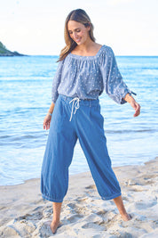 Model Tegan wearing size 10 of the Summer Daze Denim Pull On 3/4 Pant in colour Denim (Blue), from the front, showing the whole outfit