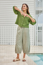 Model Tegand wearing size 10 of the Summer Daze Striped Pull On 3/4 Pant – Sage in colour Sage, from the front