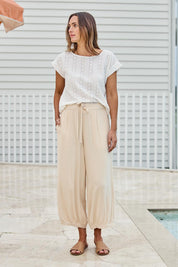 Model Tegand wearing size 10 of the Summer Daze Pull On Linen Blend Knit Pant – Sand in colour Sand, from the front