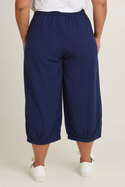 Model Ashleigh wearing size 16 of the Summer Daze Linen Blend Pull On 3/4 Pant in colour Navy (Blue), from the back