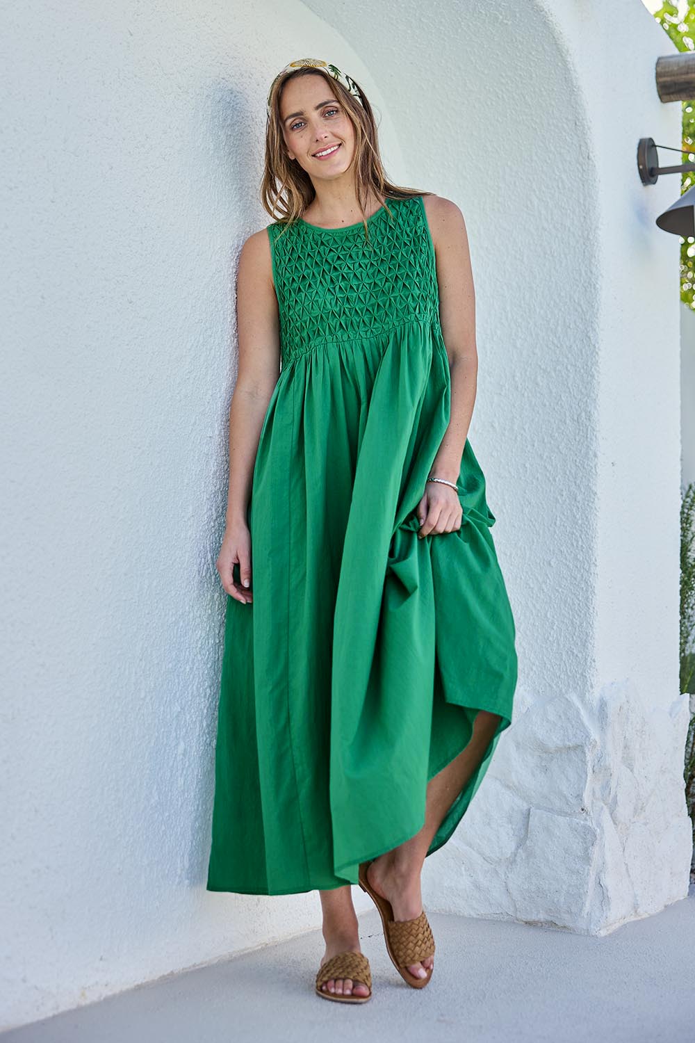 Model Tegand wearing size 10 of the Summer Breeze Smocked Cotton Dress – Green in colour Green, from the front