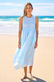 Model Tegan wearing size 10 of the Summer Breeze Smocked Cotton Dress in colour Sky (Blue), from the front, showing the whole outfit