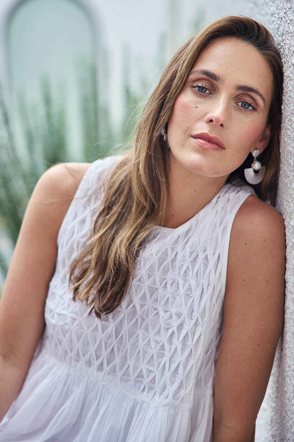 Model Tegand wearing size 10 of the Summer Breeze Smocked Cotton Dress – White in colour White, from an angle