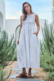 Model Tegand wearing size 10 of the Summer Breeze Smocked Cotton Dress – White in colour White, from the front