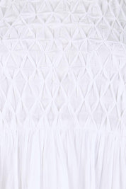 Product shot of the Summer Breeze Smocked Cotton Dress – White in colour White, showing detail