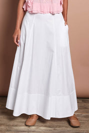 Model Riina wearing size 10 of the Timeless Love Cotton Maxi Skirt in colour White (White), from the front, cropped image