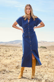 Model Tegan wearing size 10 of the Hold Me Close Denim Maxi Dress in colour Denim (Blue), from the front, showing the whole outfit