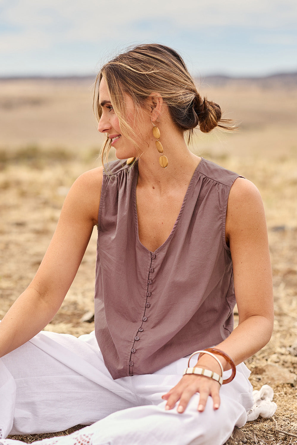 Model Tegan wearing size 10 of the Cute As A Button Cotton Tank in colour Raisin (Purple), from the front, cropped image