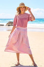 Model Tegan wearing size 10 of the Giddy For Gingham Cotton Blend Skirt in colour Rosecheck (Pink), from the front, showing the whole outfit