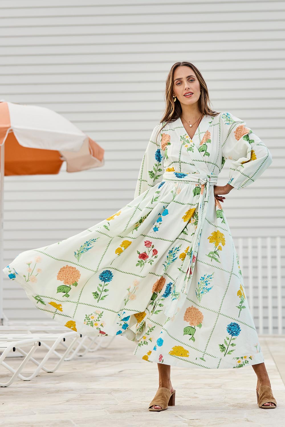 Model Tegand wearing size 10 of the Walking On Sunshine Cotton Maxi Wrap Dress – Flower in colour Flower, from the front