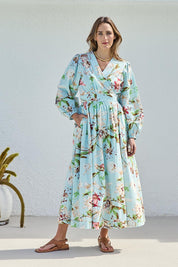Model Tegand wearing size 10 of the Walking On Sunshine Cotton Maxi Wrap Dress – Skybloom in colour Skybloom, from the front