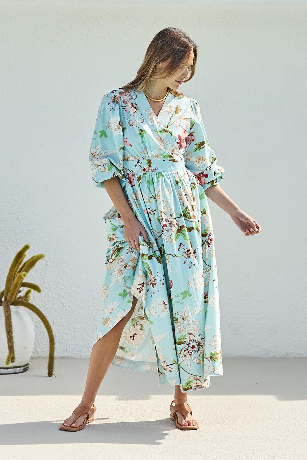 Model Tegand wearing size 10 of the Walking On Sunshine Cotton Maxi Wrap Dress – Skybloom in colour Skybloom, from the front