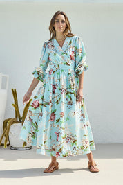 Model Tegand wearing size 10 of the Walking On Sunshine Cotton Maxi Wrap Dress – Skybloom in colour Skybloom, from the front