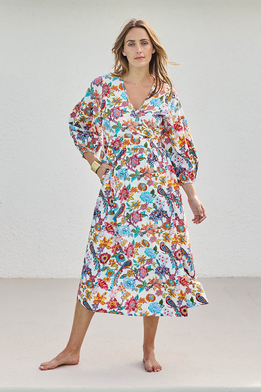 Model Tegand wearing size 10 of the Bright Bird Cotton Poplin Wrap Dress – Birdgarden in colour Birdgarden, from the front