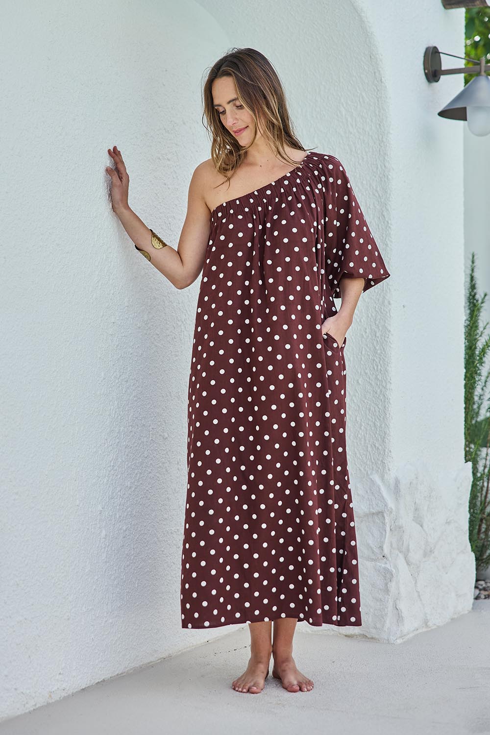 Model Tegand wearing size 10 of the Spotted You One Shoulder Cotton Maxi – Chocolate in colour Chocolate, from the front