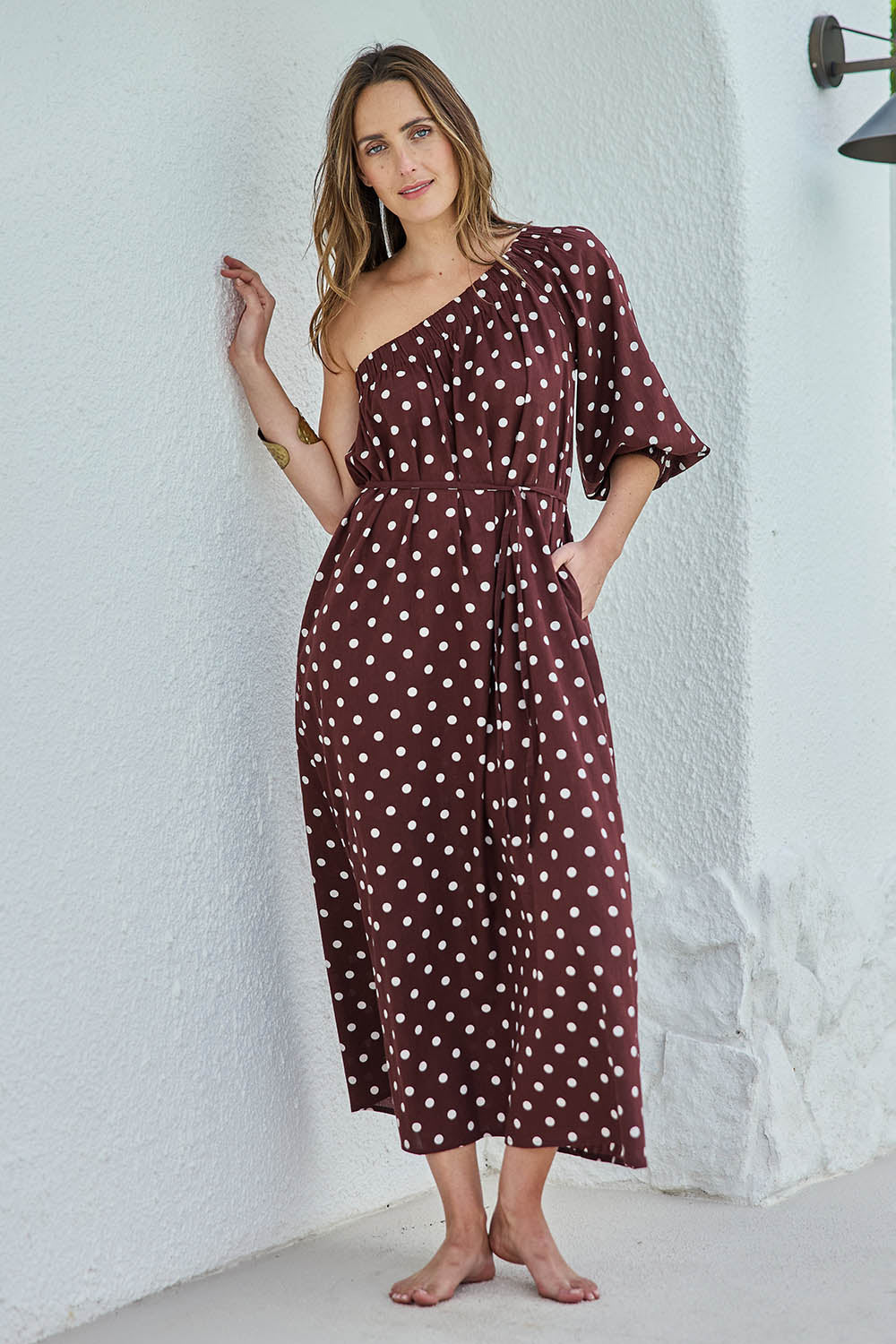 Model Tegand wearing size 10 of the Spotted You One Shoulder Cotton Maxi – Chocolate in colour Chocolate, from the front