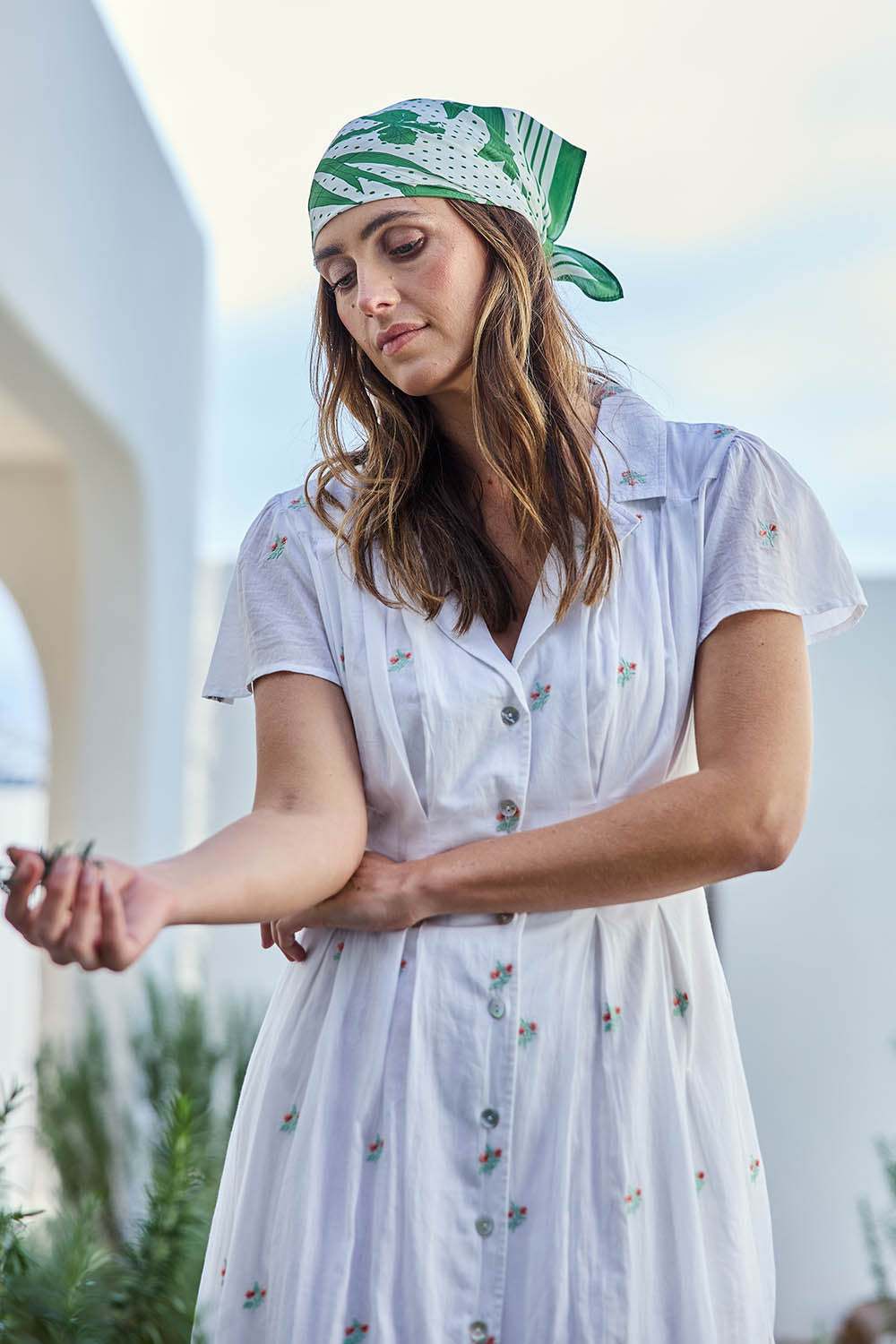 Model Tegand wearing size 10 of the Flower Field Cotton Embroidered Dress – White in colour White, in a cropped view